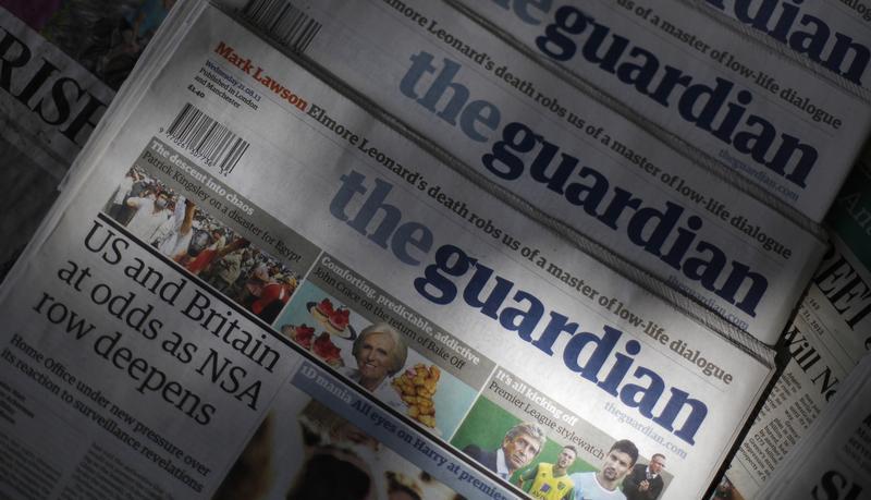 Copies of the Guardian newspaper are displayed at a news agent in London